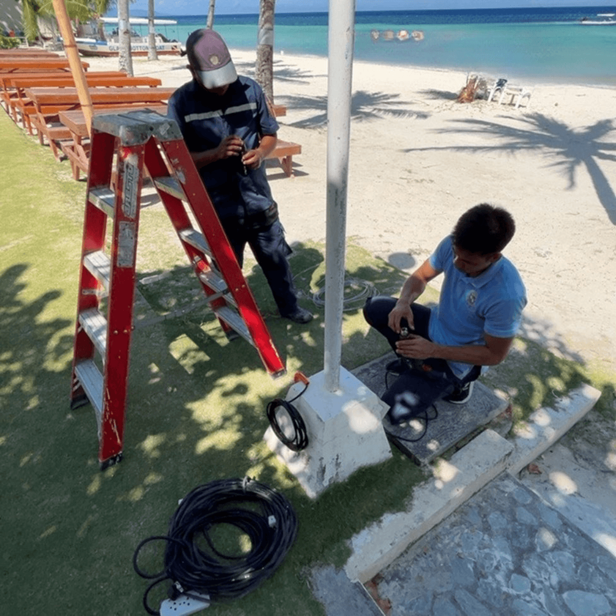15 Technician's installing cables near beach area