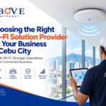 Choosing the Right Wi-Fi Solution Provider for Your Business in Cebu City Wi-Fi solution provider in Cebu City assessing business wireless coverage with a network access point, site survey tablet, and Above Infranet connectivity solutions.